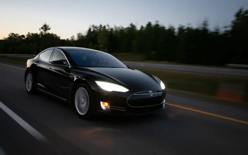 Black Tesla Model S driving